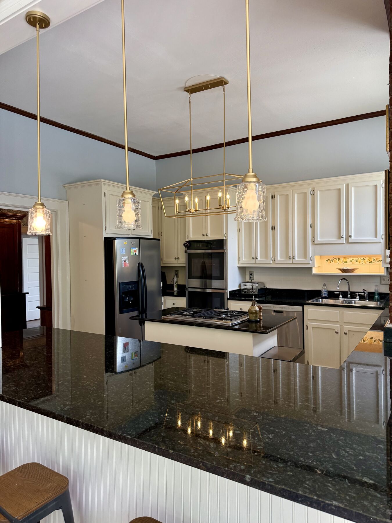 Kitchen with brass pendants and granite counters