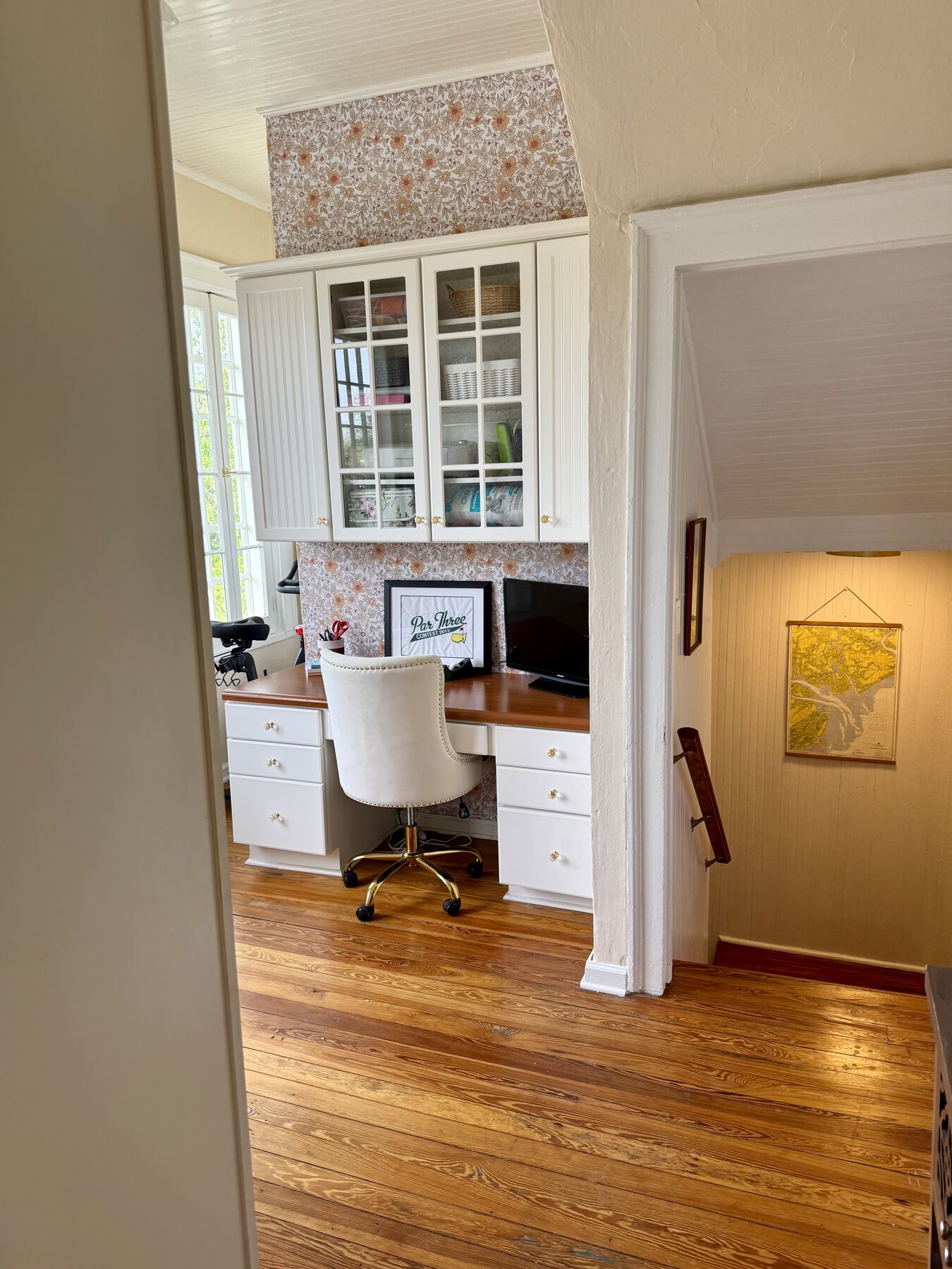 Study with floral wallpaper and built-in desk